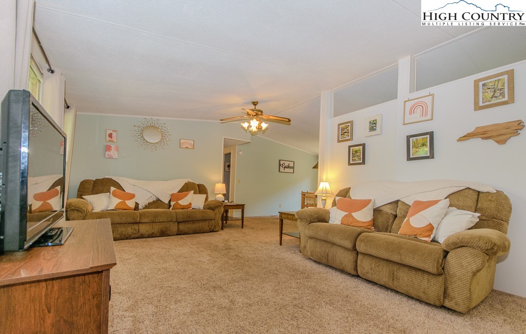 295 Roy E Brown Road Vilas, NC 28692 - Photo 13 of 43 a living room with furniture and a flat screen tv