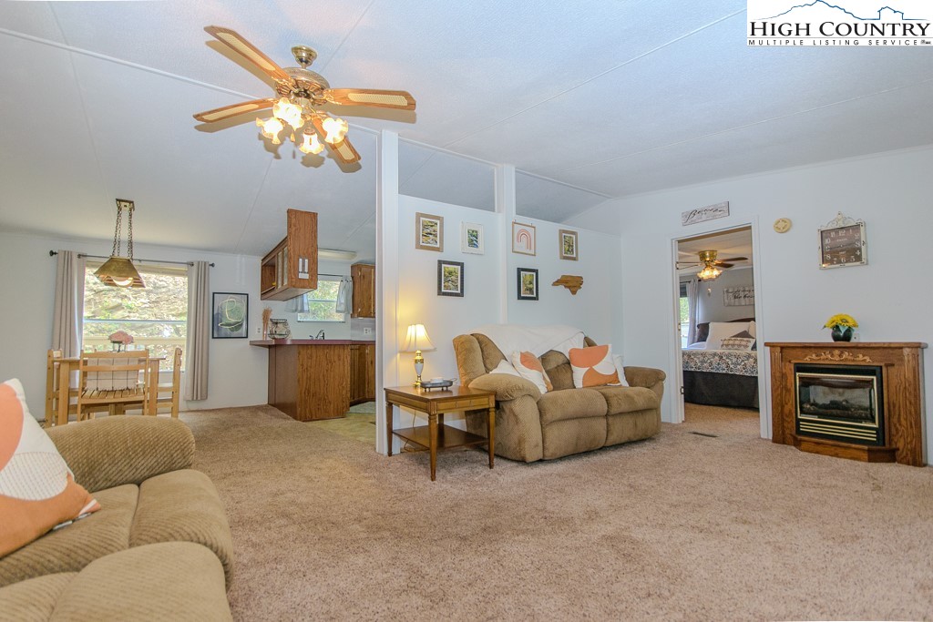 295 Roy E Brown Road Vilas, NC 28692 - Photo 16 of 43 a living room with furniture and a chandelier