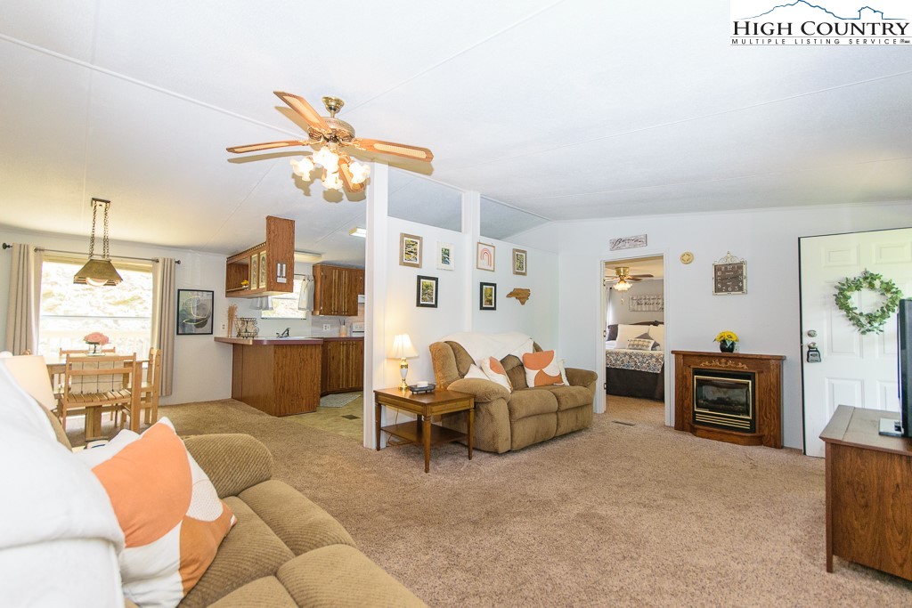 295 Roy E Brown Road Vilas, NC 28692 - Photo 19 of 43 a living room with furniture kitchen view and a chandelier