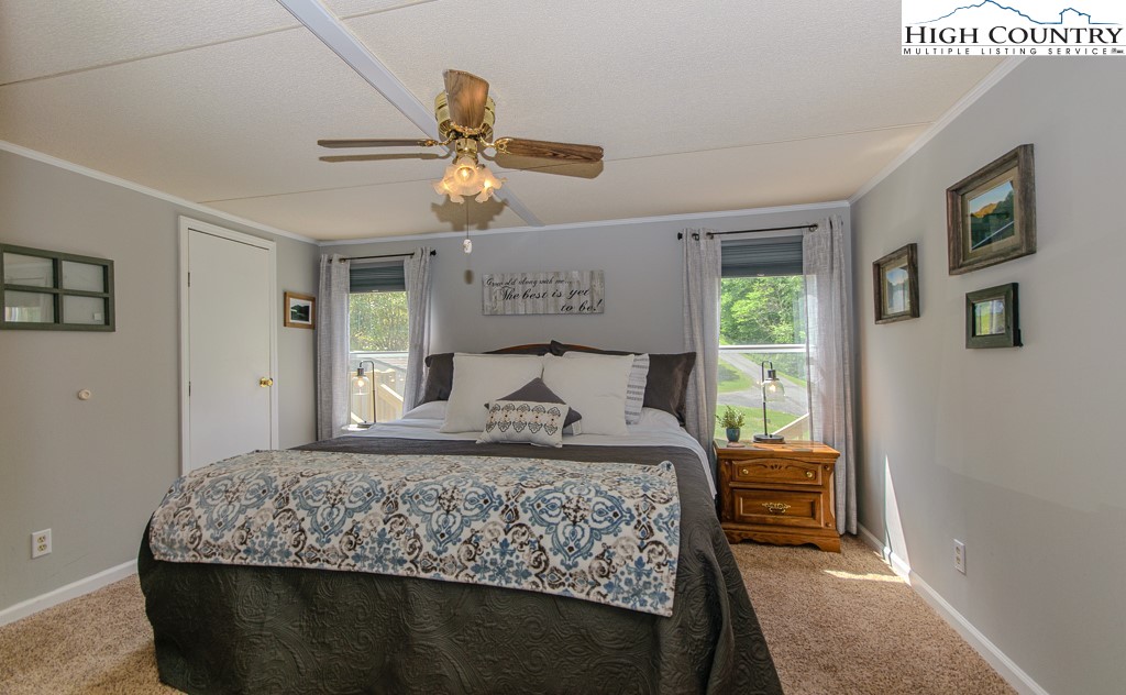295 Roy E Brown Road Vilas, NC 28692 - Photo 22 of 43 a bedroom with a large bed and a window