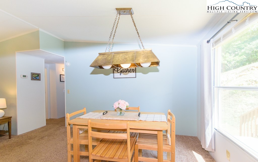 295 Roy E Brown Road Vilas, NC 28692 - Photo 28 of 43 a dining room with a window and chandelier