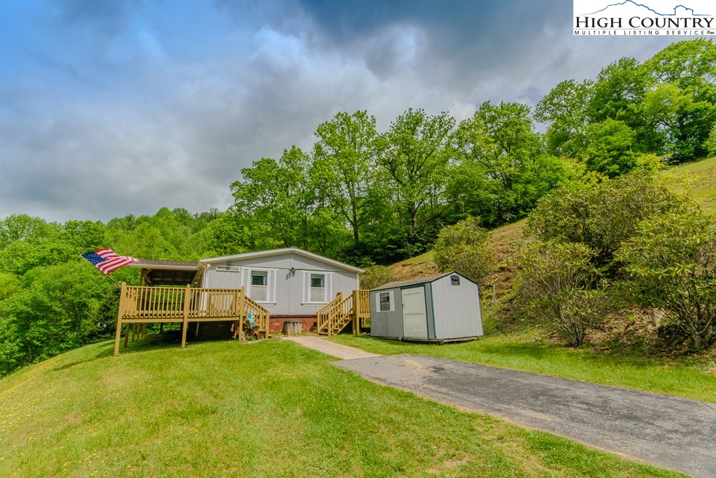 295 Roy E Brown Road Vilas, NC 28692 - Photo 3 of 43 a front view of a house with garden