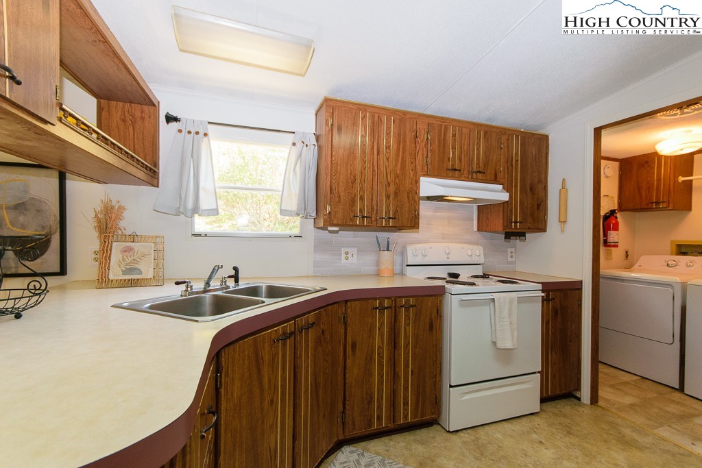 295 Roy E Brown Road Vilas, NC 28692 - Photo 31 of 43 a kitchen with a sink a stove and cabinets