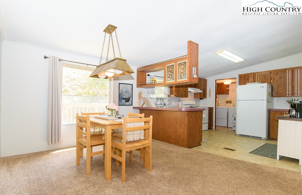 295 Roy E Brown Road Vilas, NC 28692 - Photo 34 of 43 a dining room with furniture a window and kitchen view