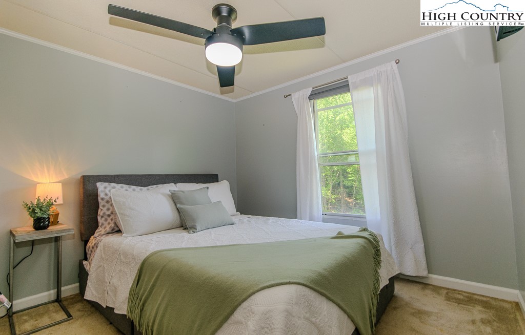 295 Roy E Brown Road Vilas, NC 28692 - Photo 35 of 43 a bedroom with a bed and a window