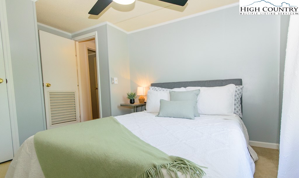 295 Roy E Brown Road Vilas, NC 28692 - Photo 36 of 43 a large bed in a bedroom next to a bathroom