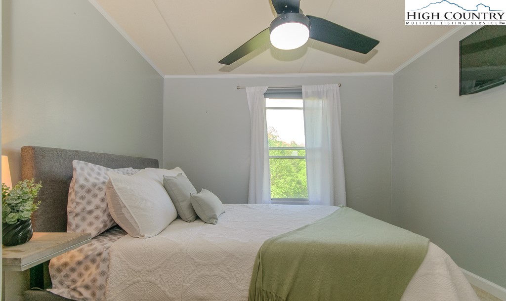 295 Roy E Brown Road Vilas, NC 28692 - Photo 37 of 43 a bedroom with a bed and a window