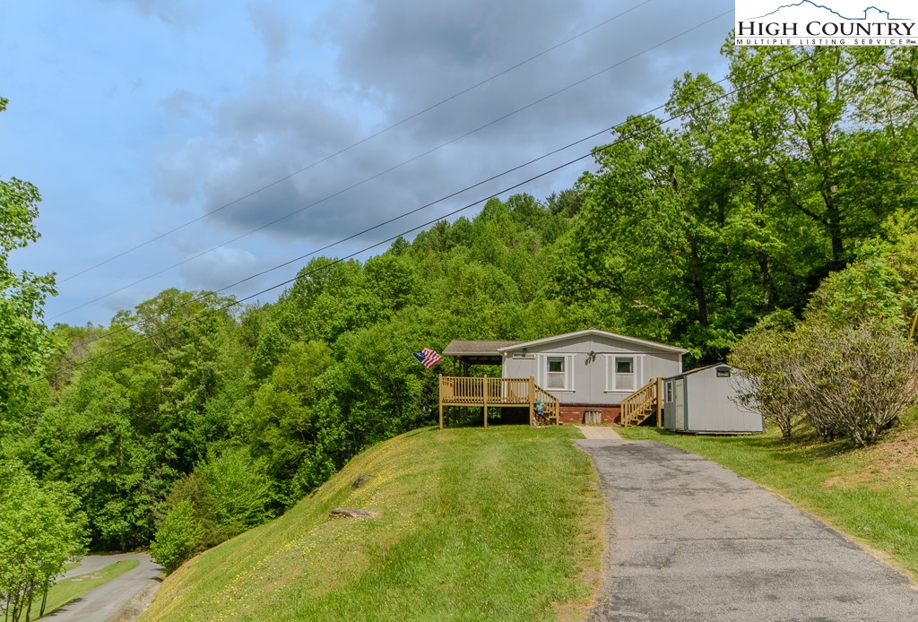 295 Roy E Brown Road Vilas, NC 28692 - Photo 41 of 43 a aerial view of a house with large trees