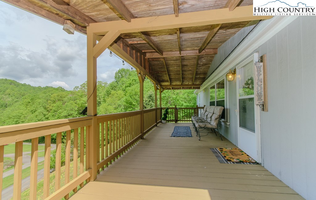 295 Roy E Brown Road Vilas, NC 28692 - Photo 5 of 43 a porch with wooden floor in outdoor space