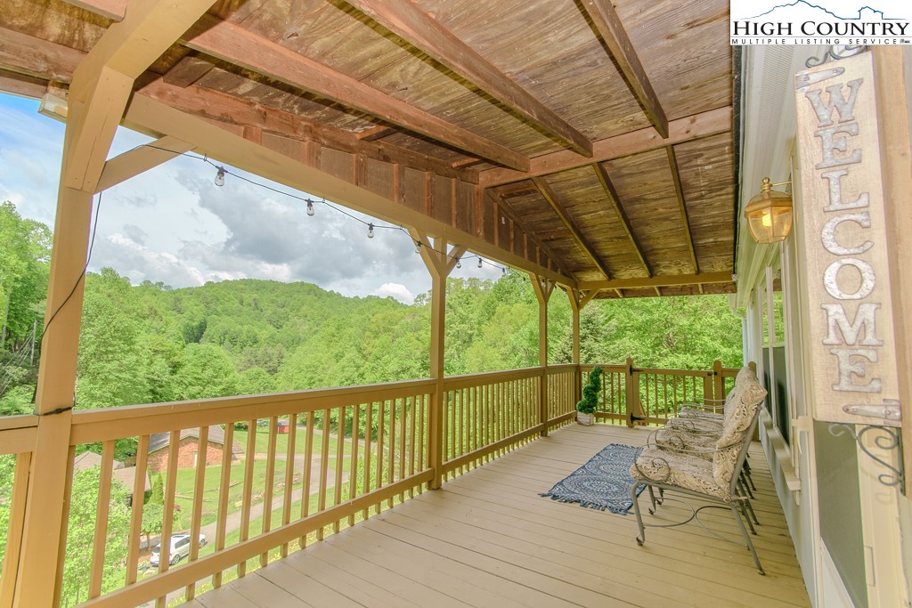 295 Roy E Brown Road Vilas, NC 28692 - Photo 8 of 43 a view of balcony with couch and wooden floor