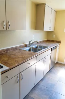 a kitchen with granite countertop a sink and a stove