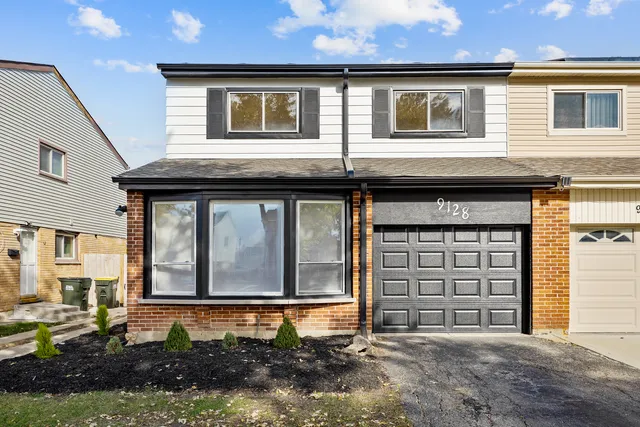 a front view of a house with a garage