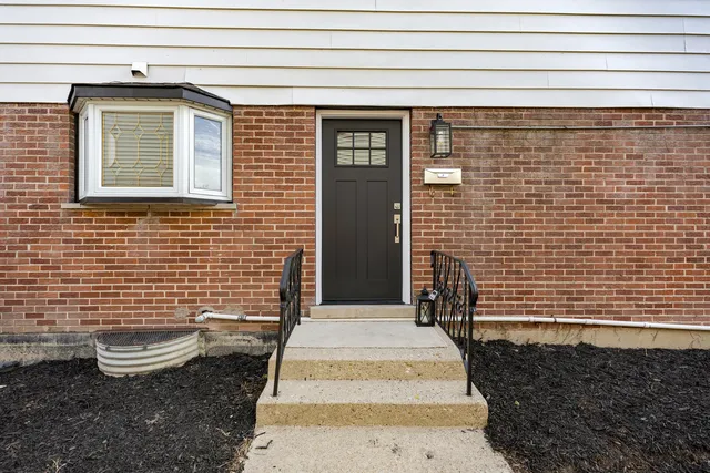 a front view of a house with many windows