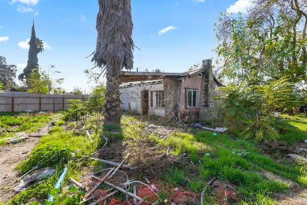 a view of a house with backyard and sitting area