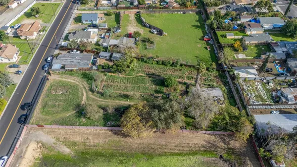 an aerial view of residential houses with outdoor space and swimming pool