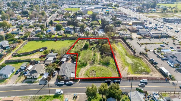 an aerial view of residential houses with outdoor space and swimming pool