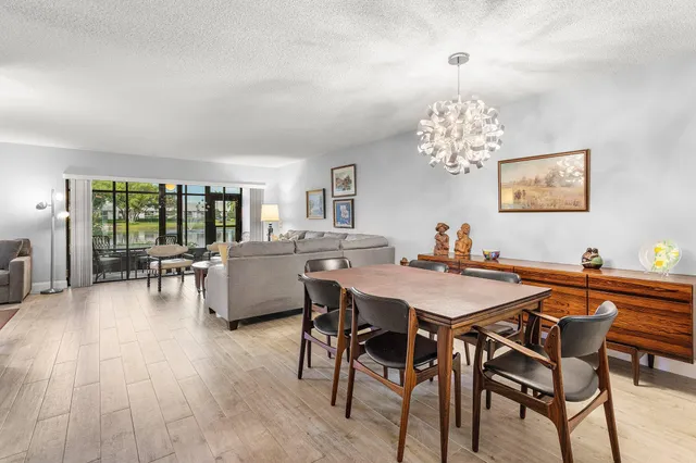 a living room with furniture a rug and a chandelier