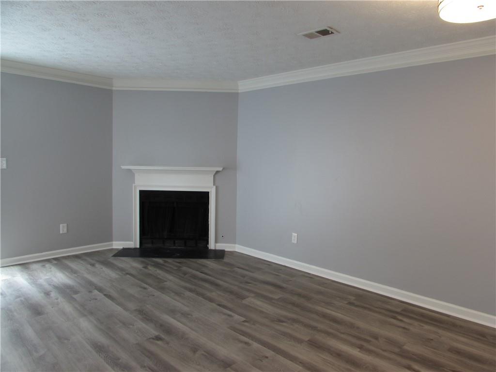 835 Heritage Valley Road Norcross, GA 30093 - Photo 15 of 34 a view of an empty room with wooden floor and a window