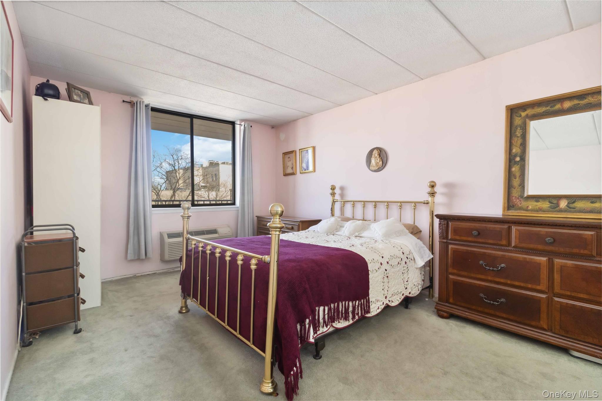 23-22 30th Road, Unit 7D Queens, NY 11102 - Photo 11 of 29 Bedroom featuring a wall mounted air conditioner and carpet