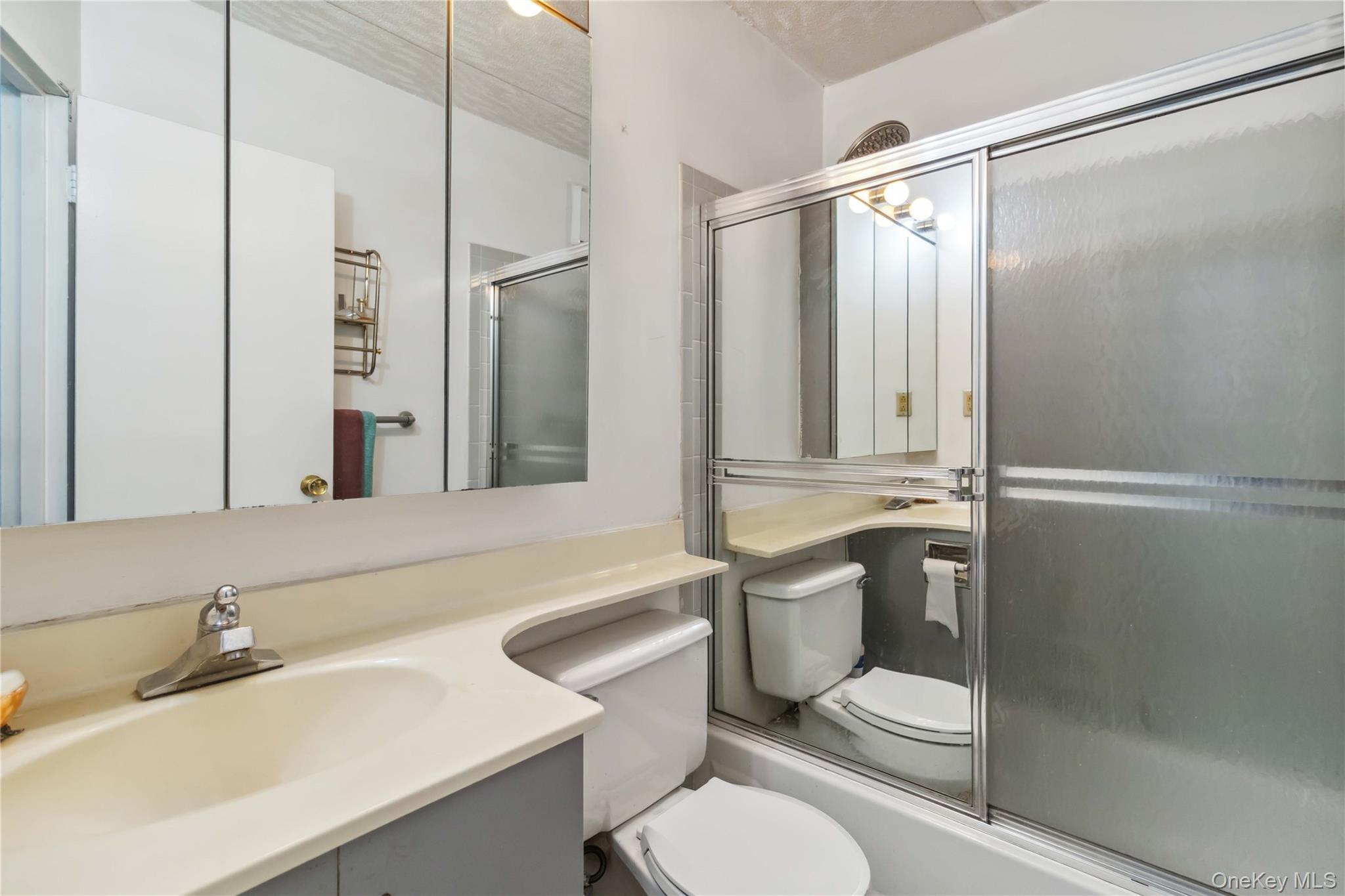 23-22 30th Road, Unit 7D Queens, NY 11102 - Photo 16 of 29 Full bathroom with toilet, vanity, and an enclosed shower
