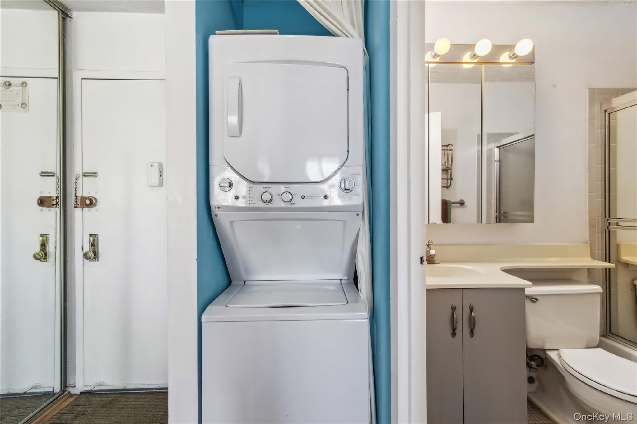 23-22 30th Road, Unit 7D Queens, NY 11102 - Photo 18 of 29 Laundry area featuring a sink, stacked washer / drying machine, and laundry area