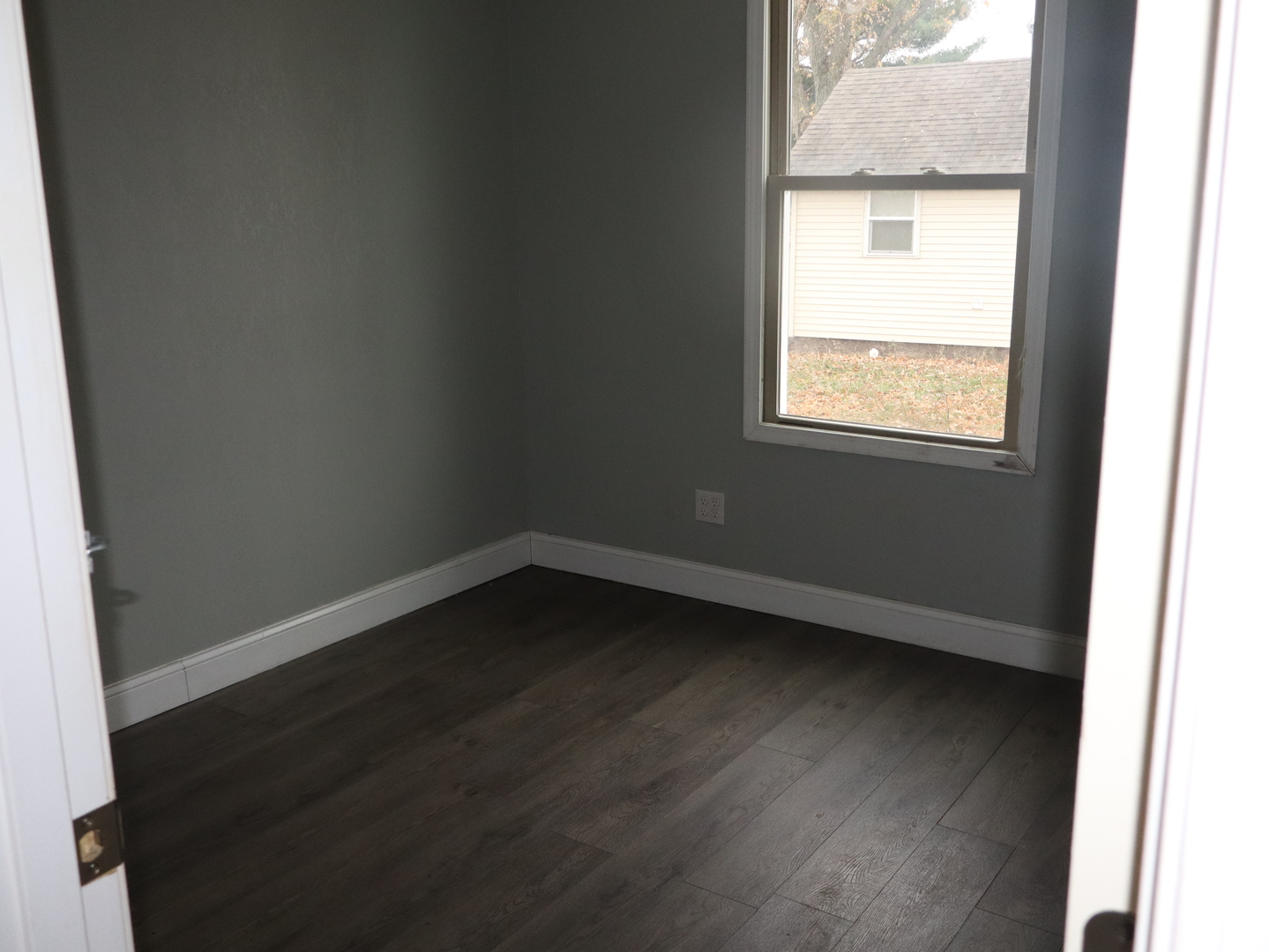 4603 Cleveland Street Streator, IL 61364 - Photo 15 of 16 an empty room with wooden floor and windows