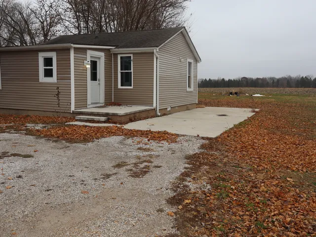 a view of a house with a yard and lake view