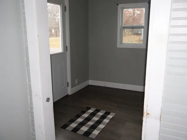 a view of an entryway with wooden floor