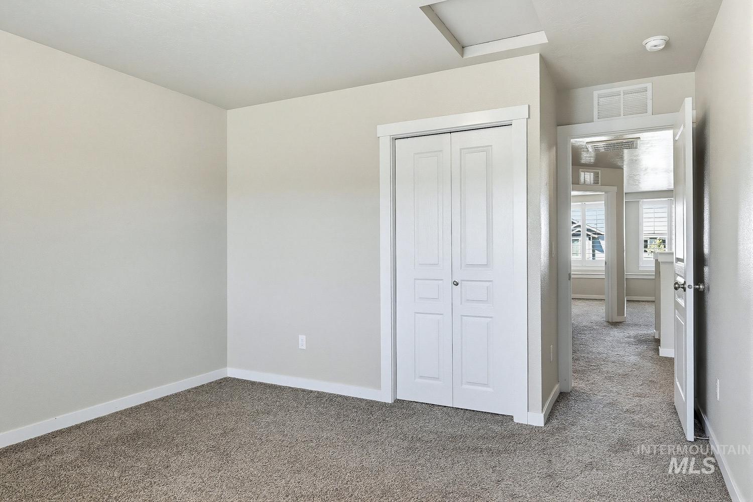 846 North Hidden View Way Star, ID 83669 - Photo 43 of 49 Neutral-toned room featuring light gray walls, plush gray carpet, a white bi-fold closet, and white trim