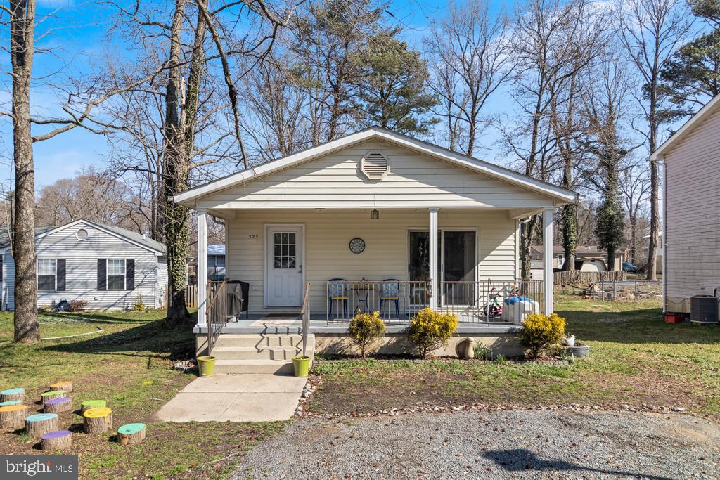 323 Laurel Drive Lusby, MD 20657 - Photo 14 of 15 a front view of a house with garden