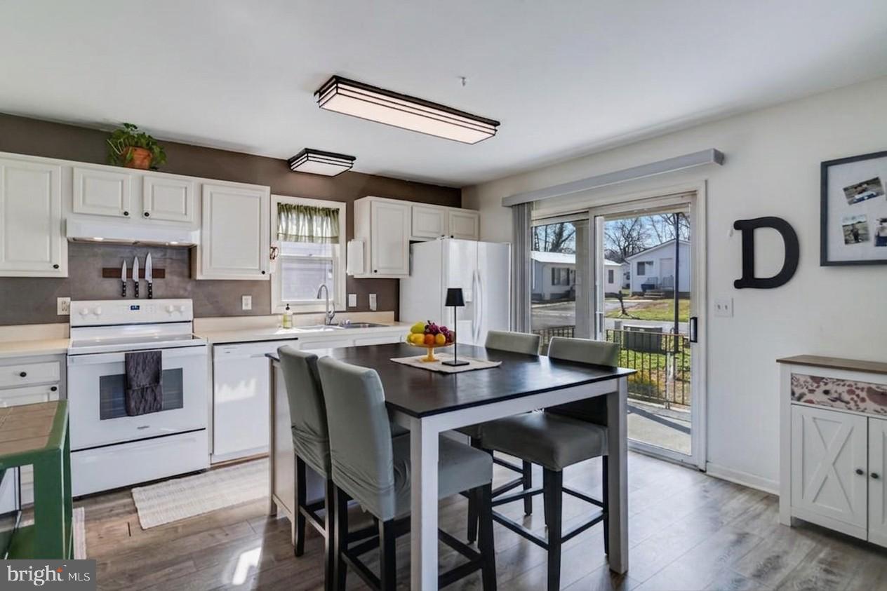 323 Laurel Drive Lusby, MD 20657 - Photo 8 of 15 a kitchen with a table and chairs in it