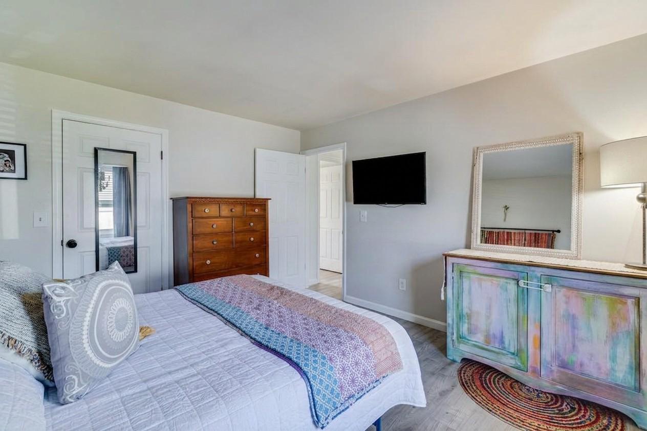 323 Laurel Drive Lusby, MD 20657 - Photo 10 of 15 a bedroom with a bed and a flat tv screen on dresser