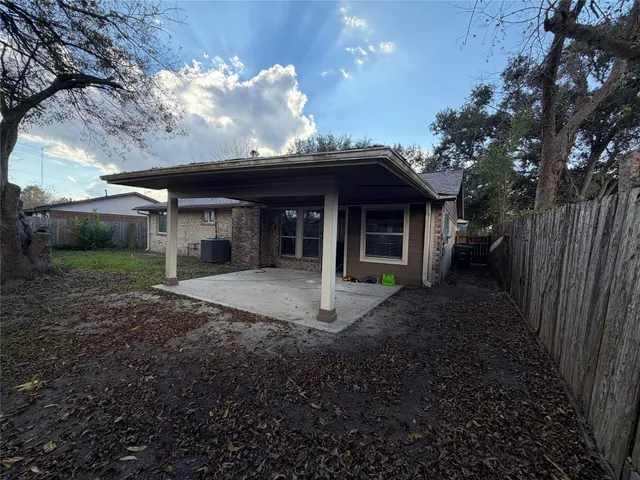 a view of a house with backyard and porch