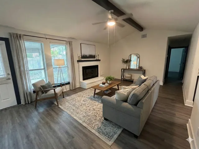 a living room with furniture and a fireplace