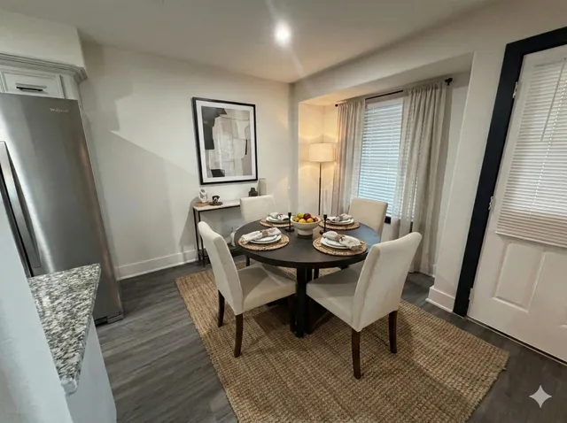 a view of a dining room with furniture and wooden floor