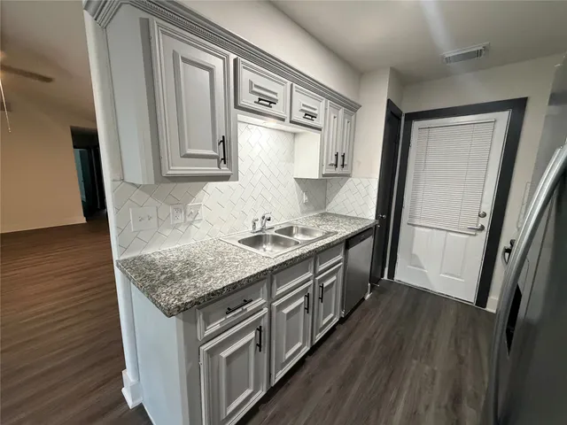 a kitchen with a sink stove and refrigerator