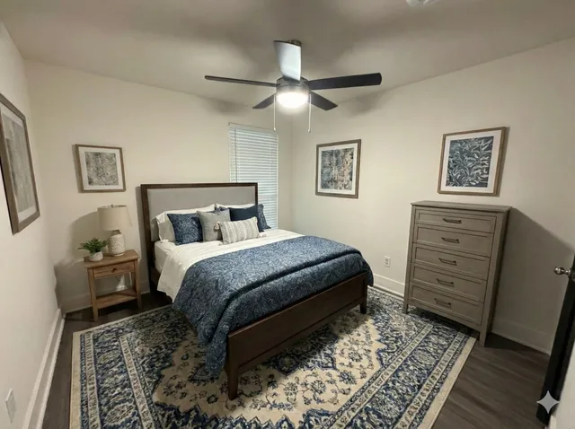 a bedroom with a bed and a dresser
