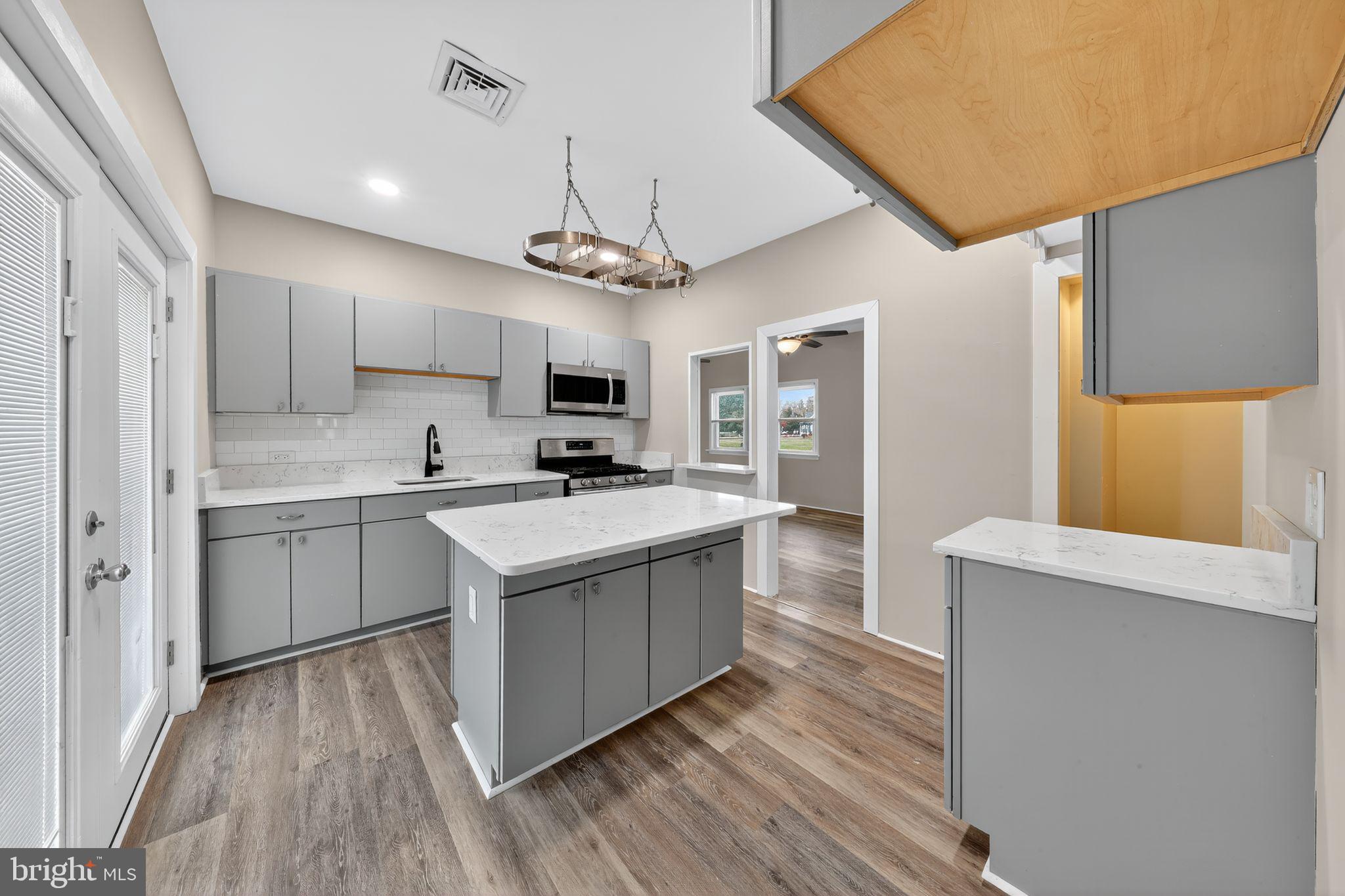 121 Ash Street Carneys Point, NJ 08069 - Photo 14 of 30 a kitchen with a stove a sink and a refrigerator