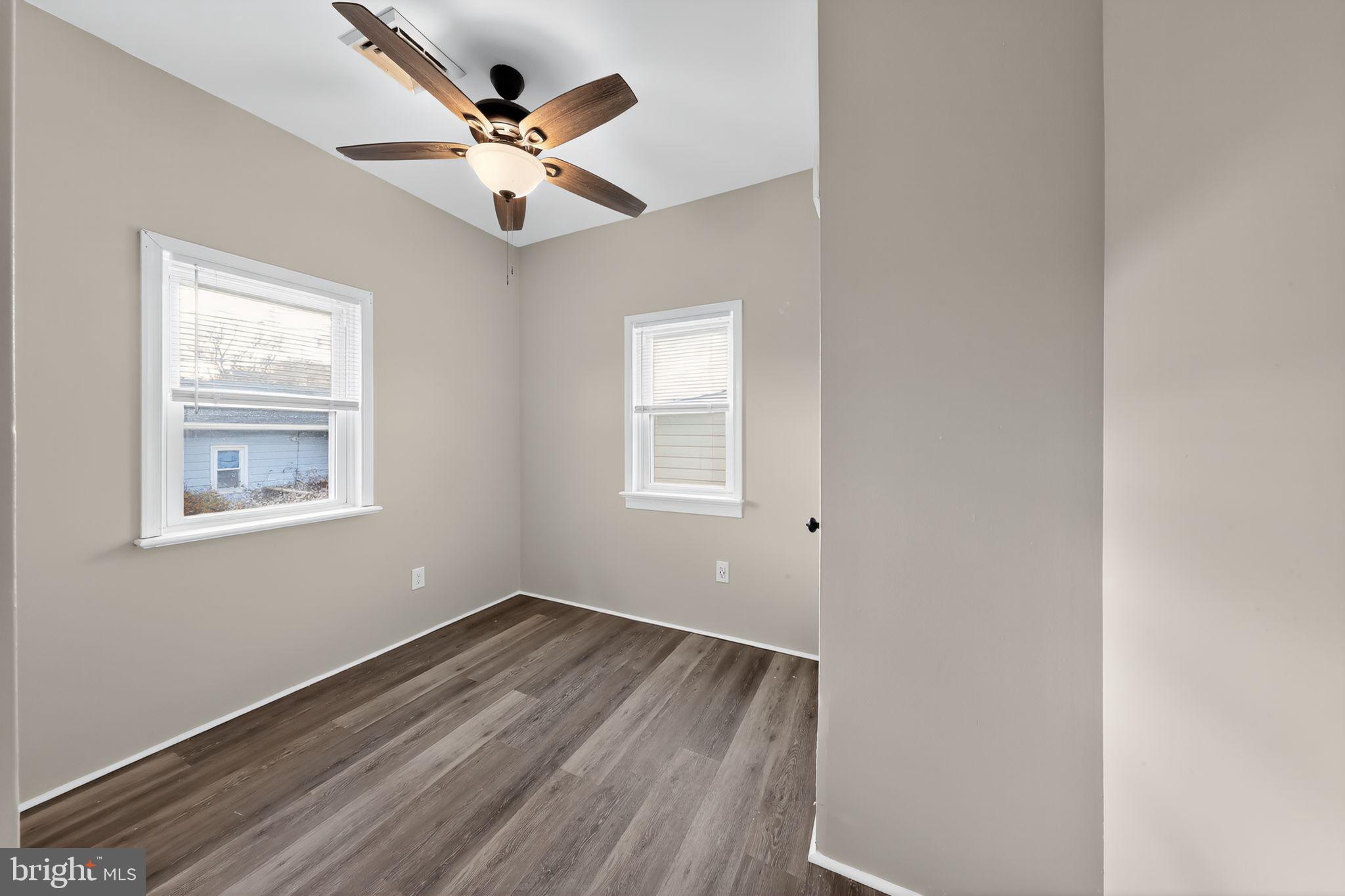 121 Ash Street Carneys Point, NJ 08069 - Photo 16 of 30 a view of an empty room with wooden floor and a ceiling fan
