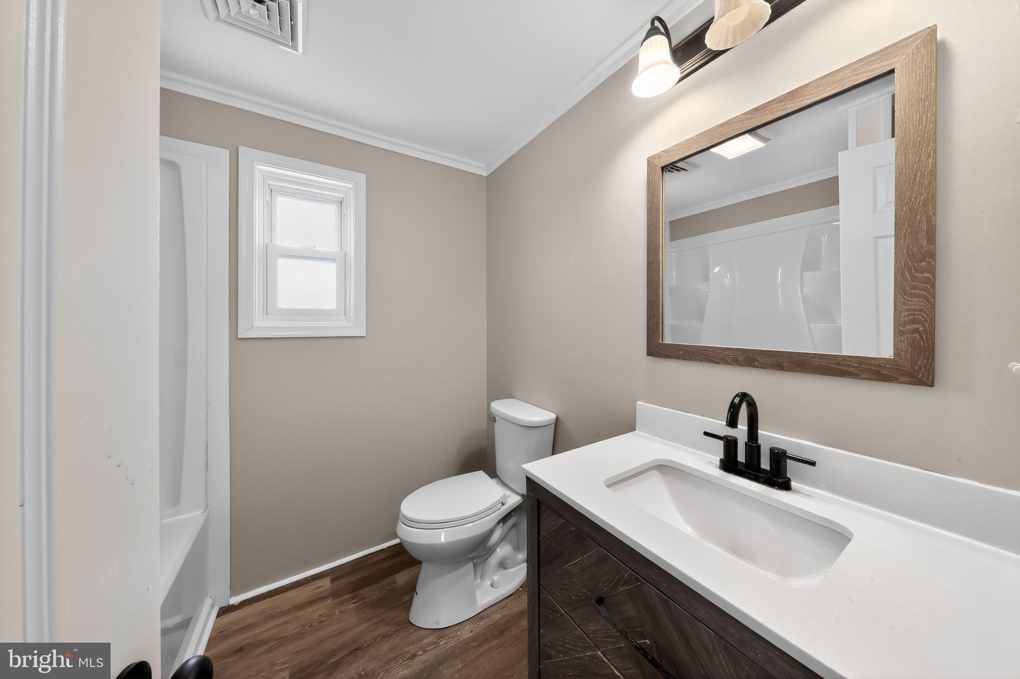 121 Ash Street Carneys Point, NJ 08069 - Photo 23 of 30 a bathroom with a toilet sink and mirror