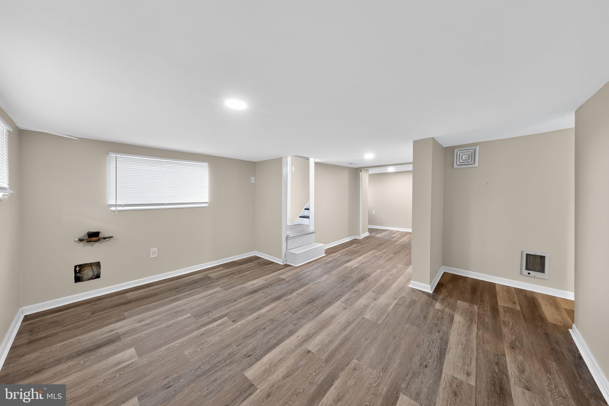 121 Ash Street Carneys Point, NJ 08069 - Photo 25 of 30 a view of an empty room with wooden floor and a window