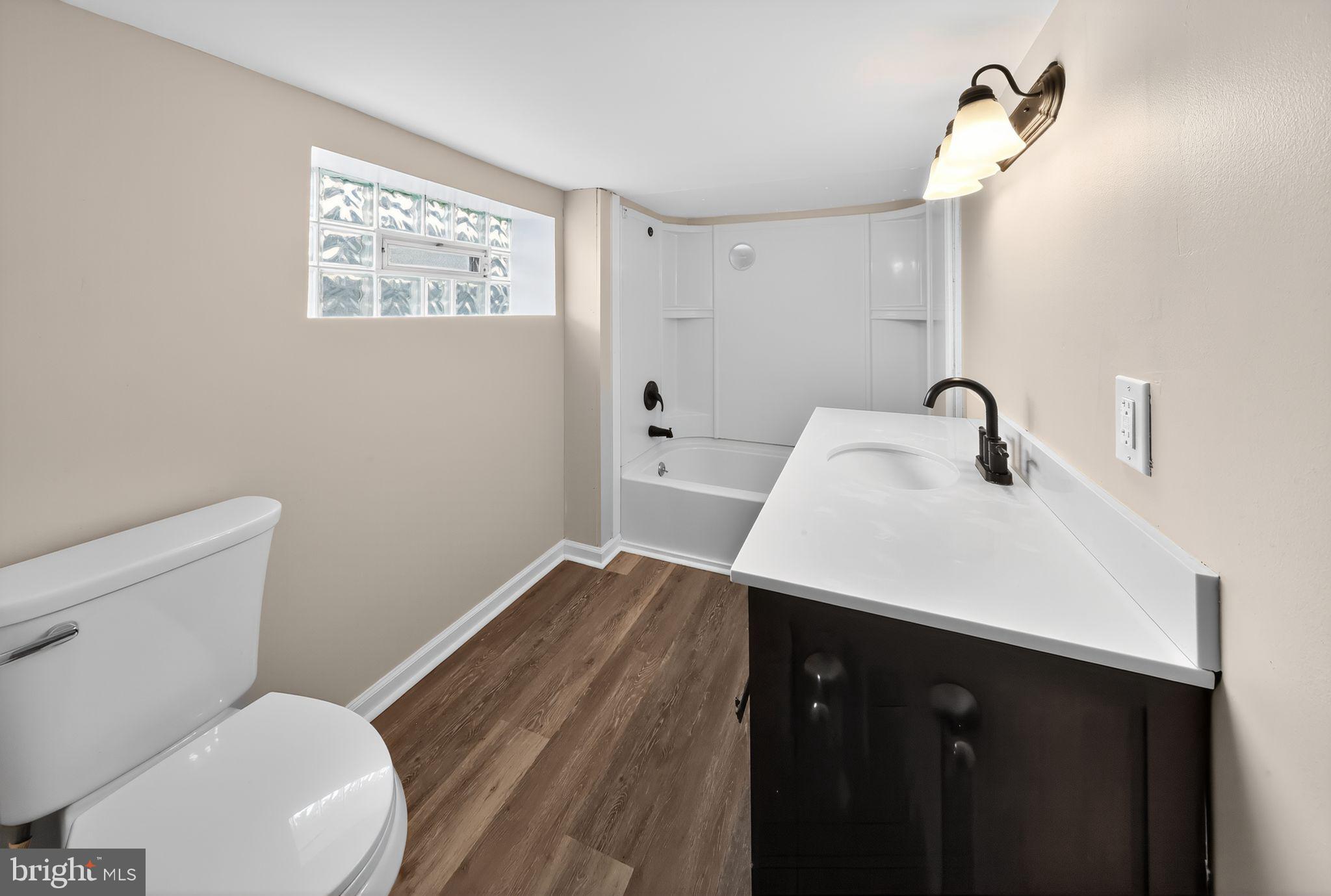 121 Ash Street Carneys Point, NJ 08069 - Photo 26 of 30 a bathroom with a sink vanity mirror and toilet