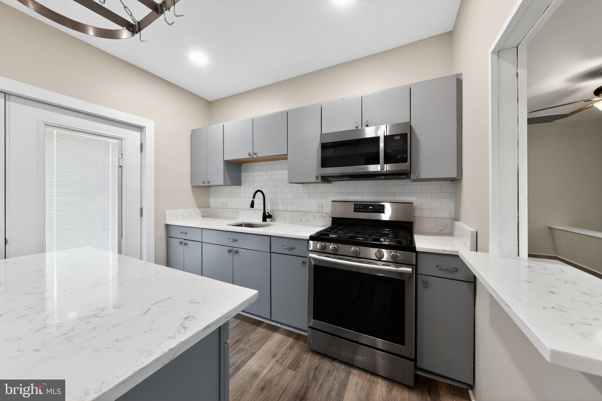 121 Ash Street Carneys Point, NJ 08069 - Photo 10 of 30 a kitchen with a stove and a sink