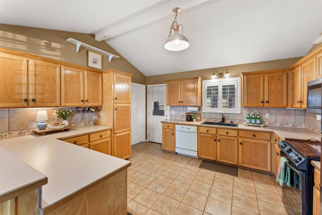 2700 Auction Barn Road Belton, TX 76513 - Photo 11 of 38 a large kitchen with kitchen island granite countertop a sink counter space appliances and a window