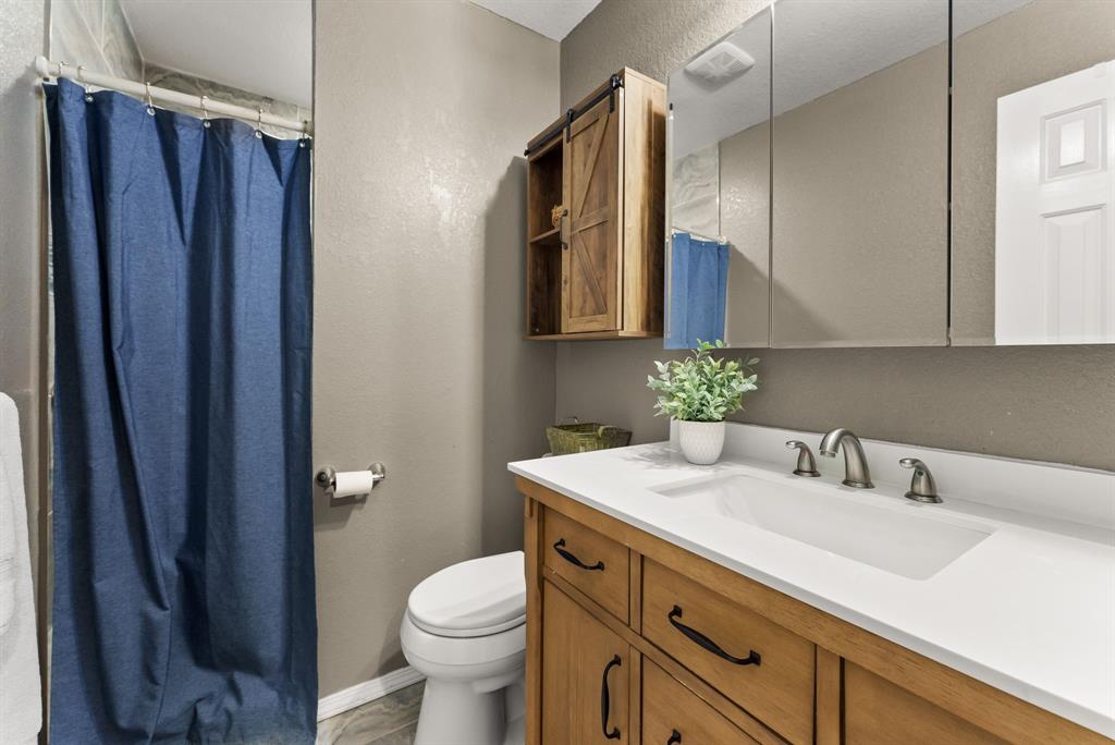 2700 Auction Barn Road Belton, TX 76513 - Photo 15 of 38 a bathroom with a sink a toilet and shower