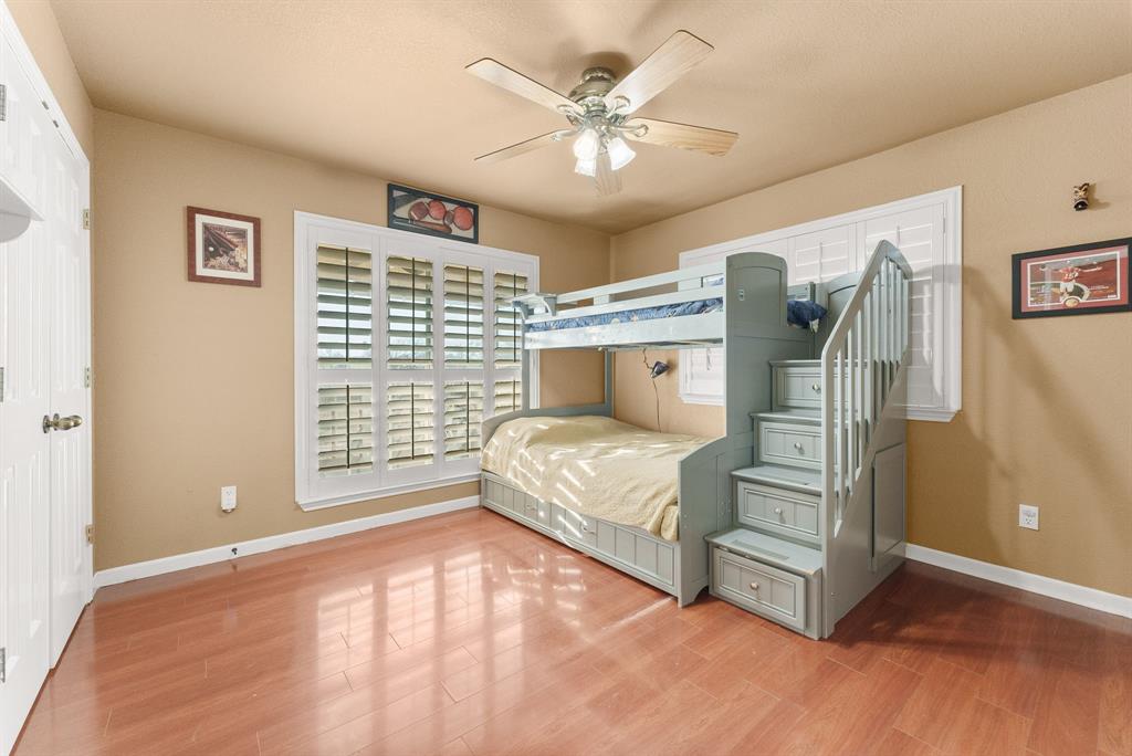 2700 Auction Barn Road Belton, TX 76513 - Photo 17 of 38 a bedroom with a large bed and a ceiling fan