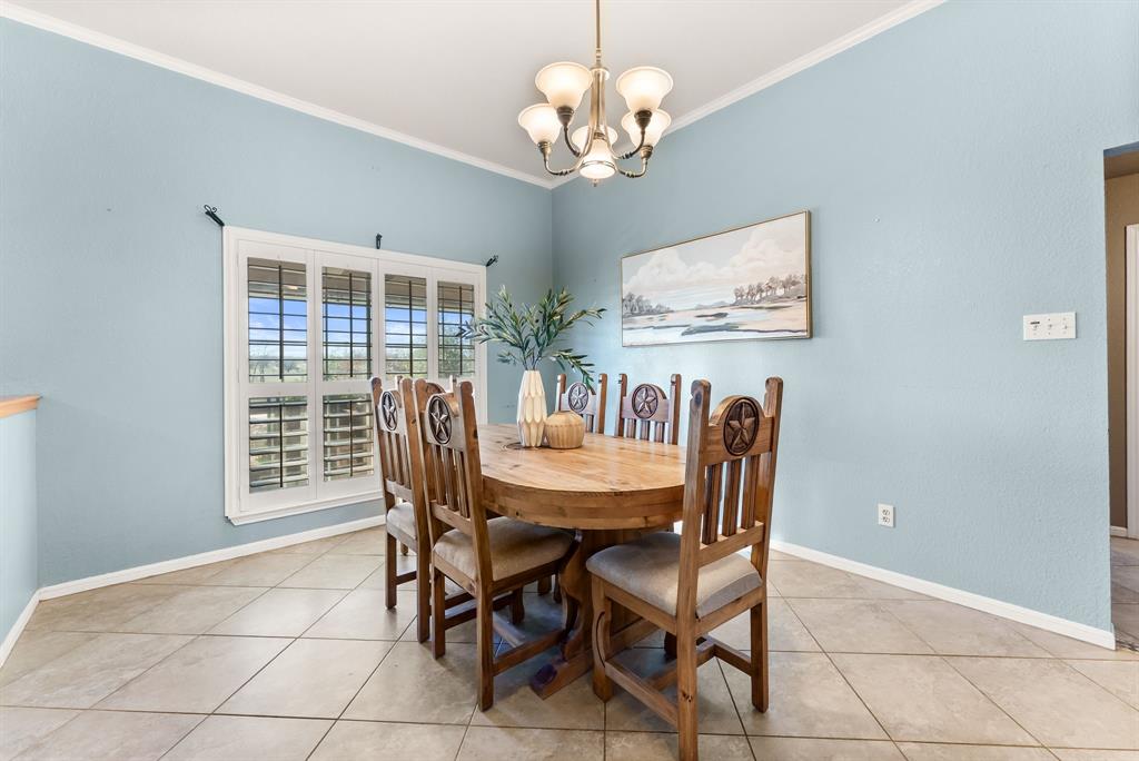 2700 Auction Barn Road Belton, TX 76513 - Photo 8 of 38 a view of a dining room with furniture a chandelier and window