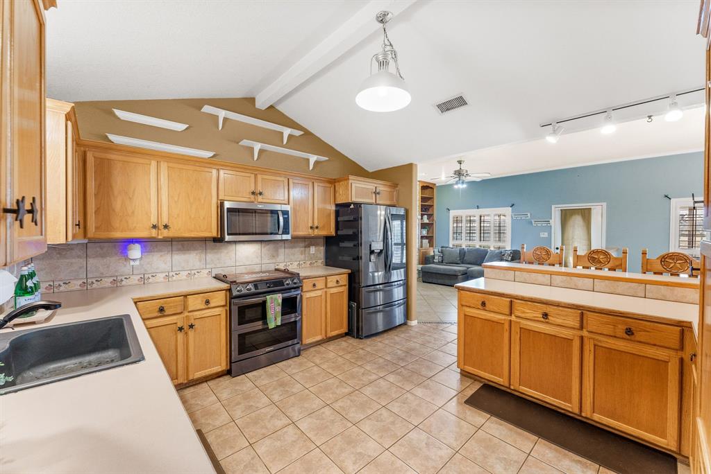 2700 Auction Barn Road Belton, TX 76513 - Photo 10 of 38 a large kitchen with stainless steel appliances granite countertop a stove and a sink