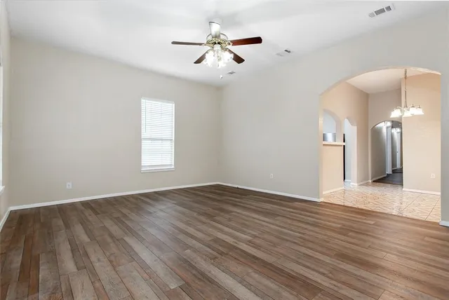 wooden floor in an empty room with a window