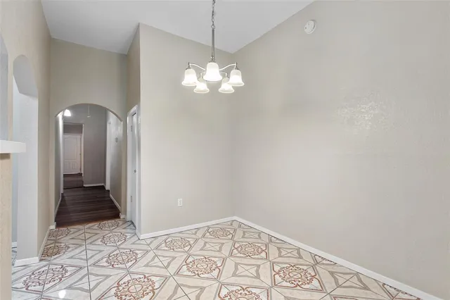 a view of a chandelier fan and wooden floor